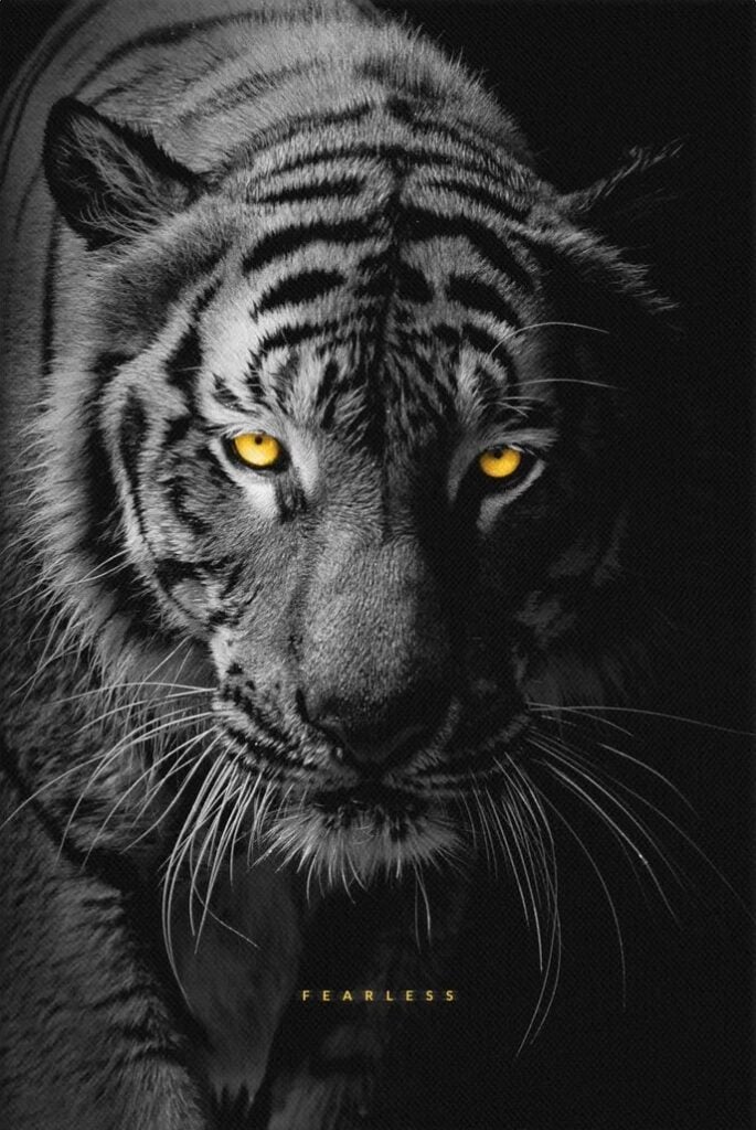 A black and white tiger with glowing orange eyes glares at the viewer. "Fearless."